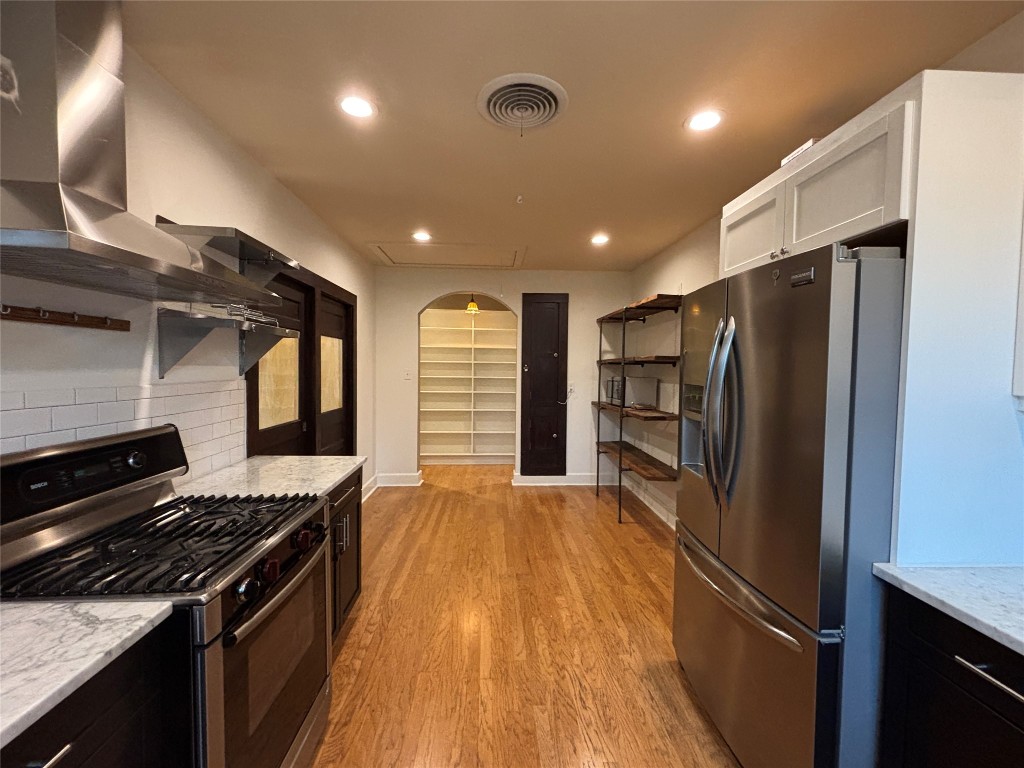5808 Coventry Lane Austin, TX 78723 - Photo 8 of 27 a kitchen with stainless steel appliances granite countertop a refrigerator and a stove