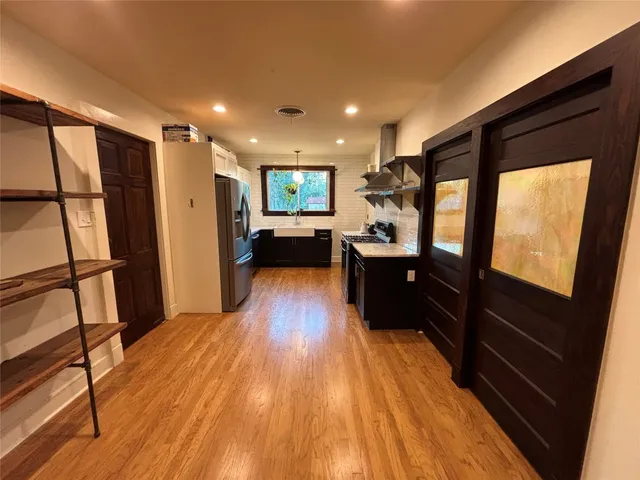 a view of living room with furniture and wooden floor