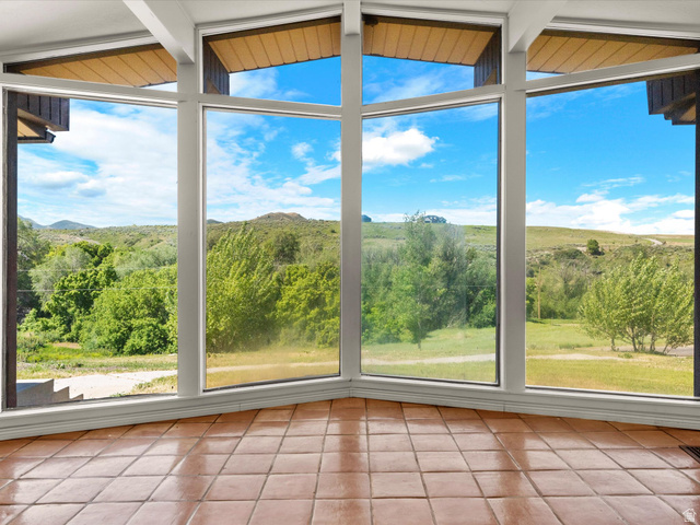 15680 North Beaver Dam Road Collinston, UT 84306 - Photo 4 of 49 Expansive corner window array with white framing and exposed wood ceiling accents