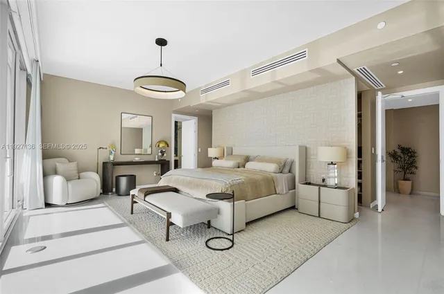 a bedroom with a large bed and a flat screen tv