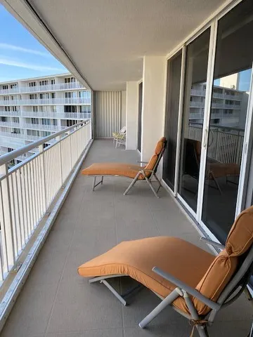 a bedroom with two beds and a chandelier