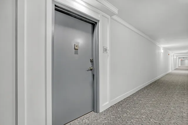 a dining room with furniture and a chandelier
