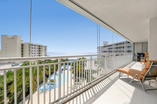 a bathroom with a granite countertop sink a toilet and a large mirror