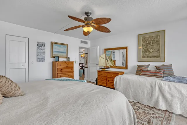 a bathroom with a granite countertop sink a toilet and a mirror
