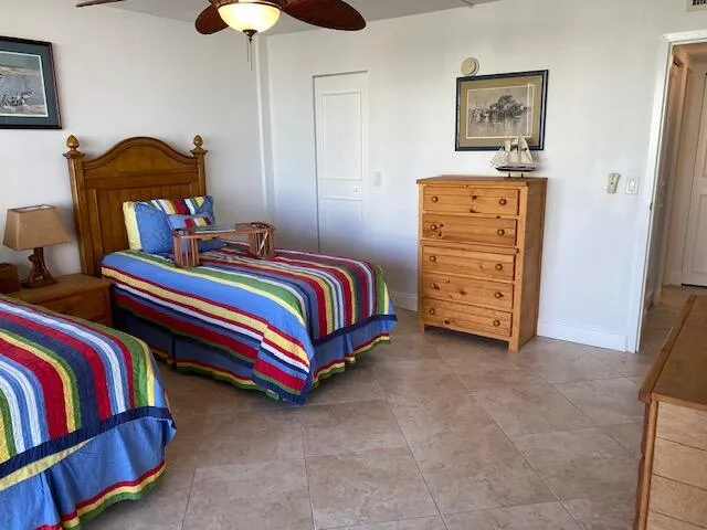 a front view of multi story residential apartment building with yard and green space