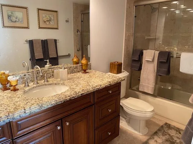 a room with lots of furniture and view of kitchen