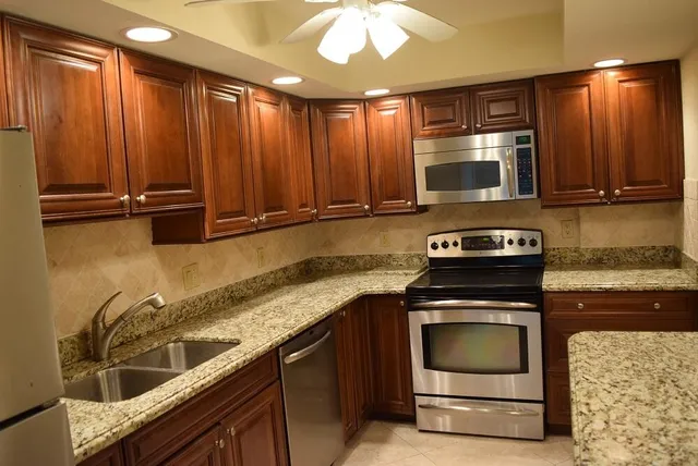 a kitchen with a refrigerator and table