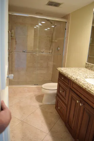 a view of a swimming pool with a table and chairs under an umbrella