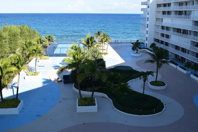 a bedroom with furniture and a refrigerator