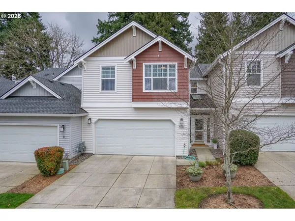 a view of a house with a yard and a garage