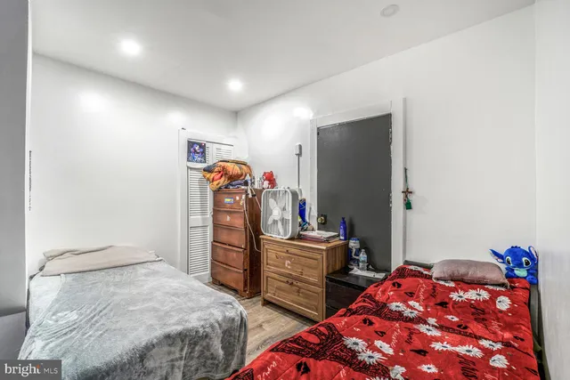 a bedroom with two beds and a closet