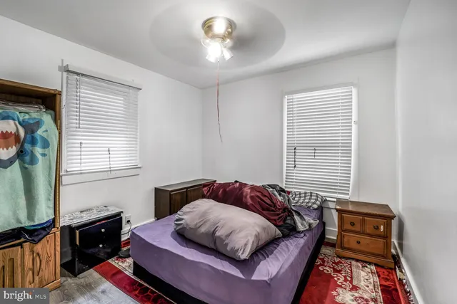 a bedroom with a bed dresser and a window