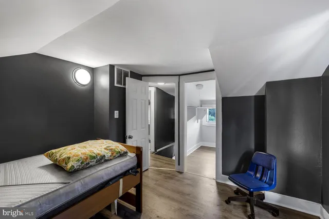 a bedroom with a bed and a mirror