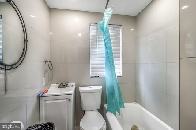 a bathroom with a toilet a sink and a window