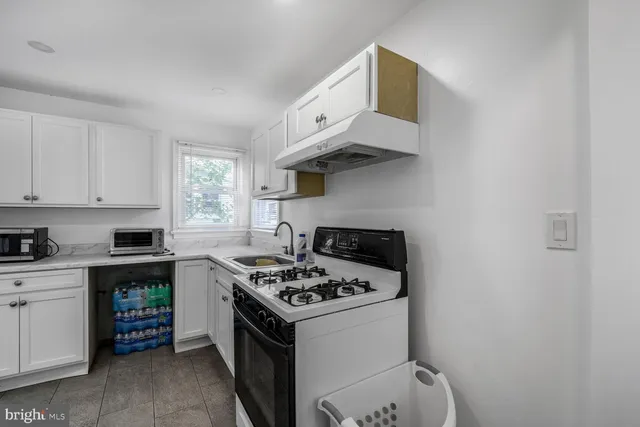 a kitchen with cabinets appliances and a window