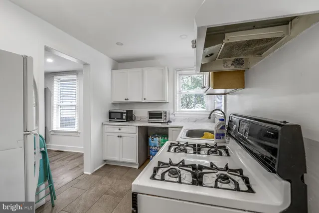 a kitchen with a stove a sink and a microwave