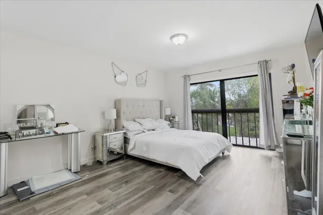 a bedroom with a bed and large window