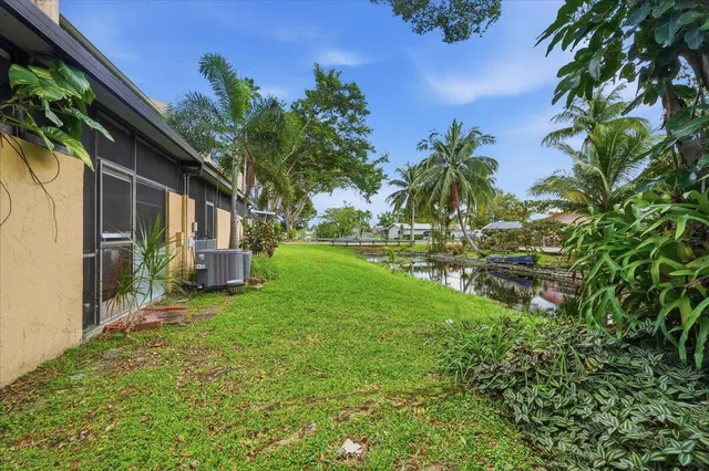 a view of backyard of house with green space