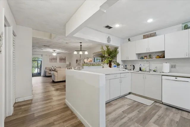 a kitchen with cabinets a sink and appliances