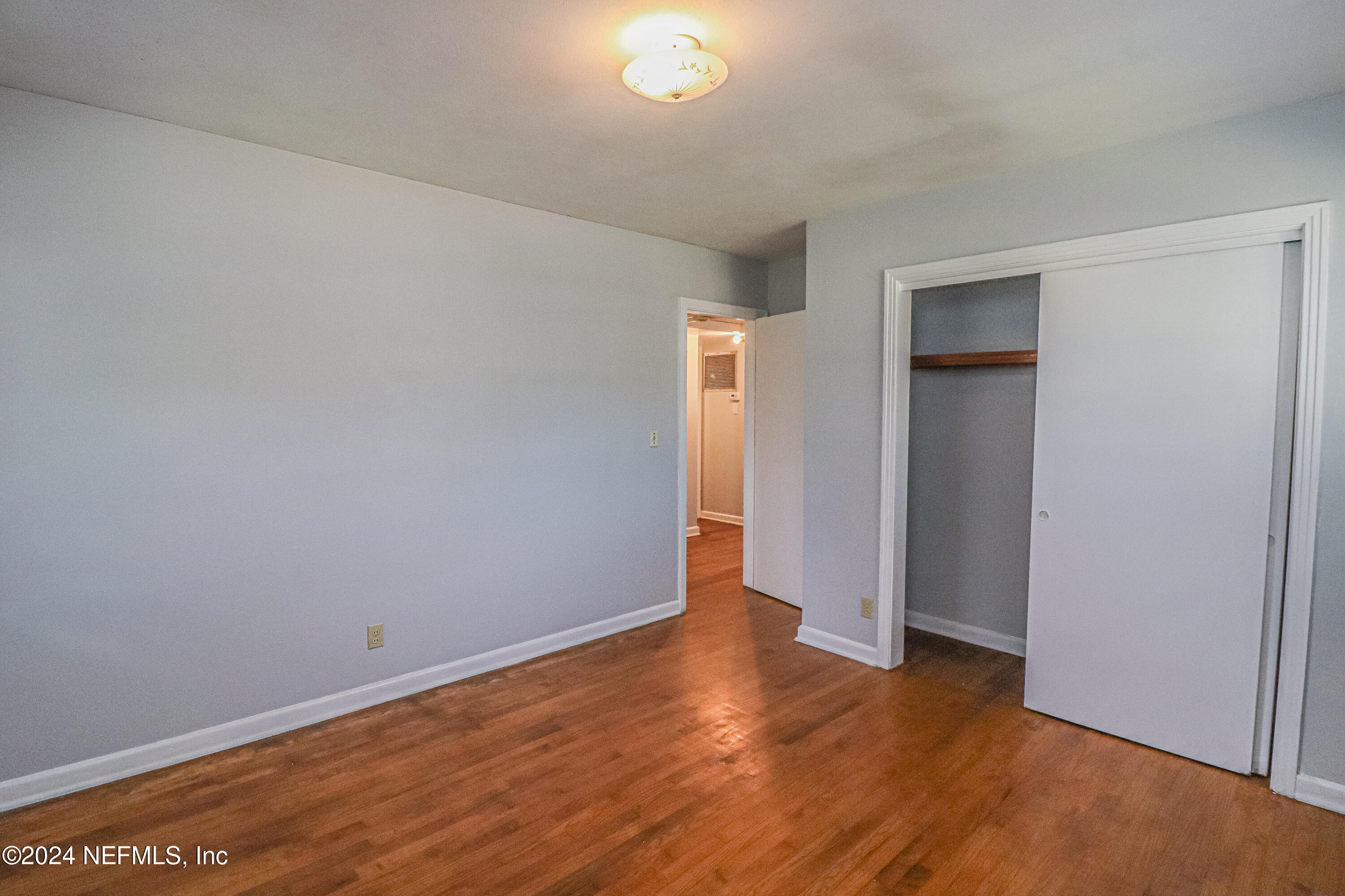 6503 Ector Road Jacksonville, FL 32211 - Photo 16 of 25 a view of an empty room with wooden floor and closet