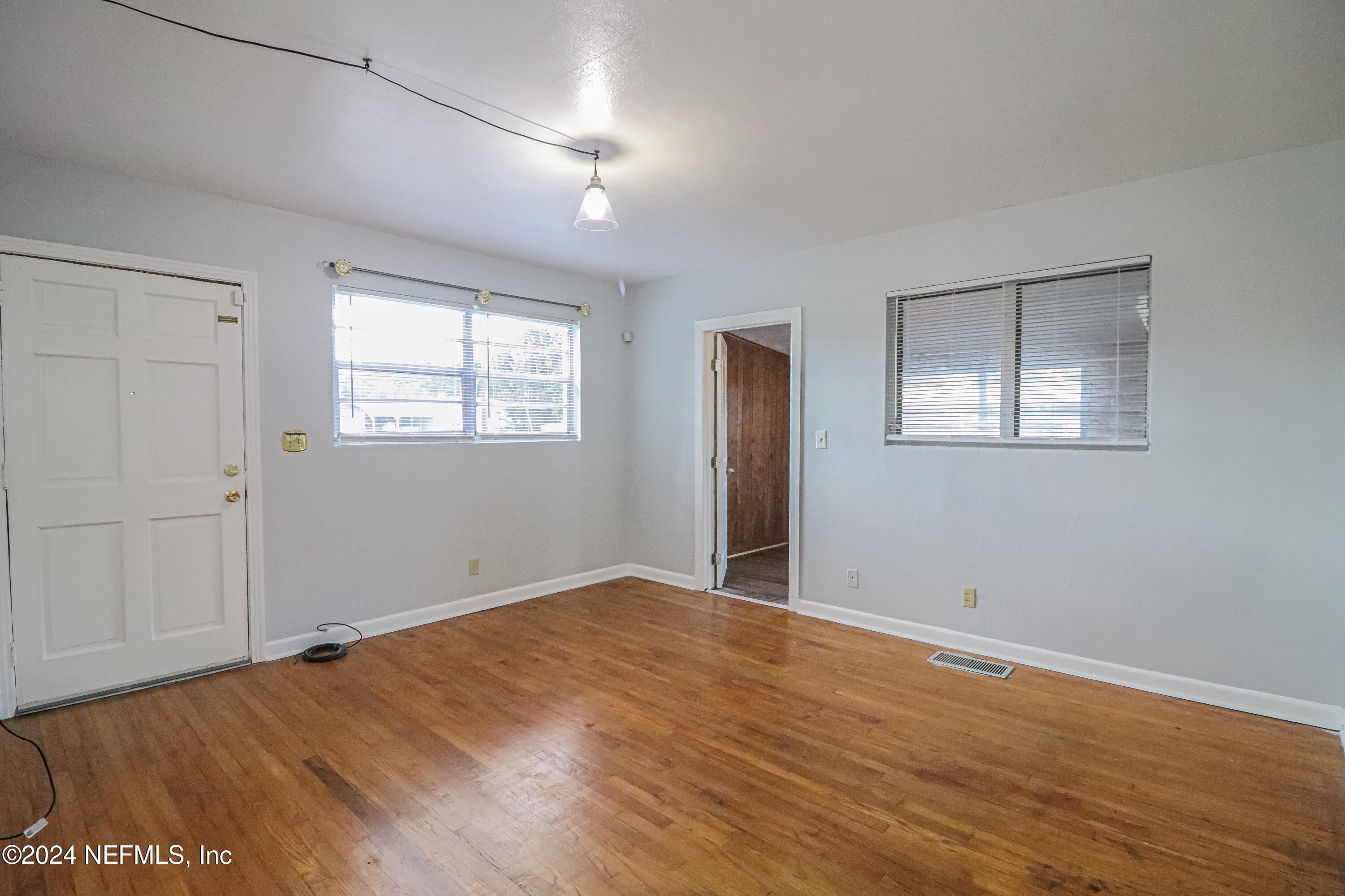 6503 Ector Road Jacksonville, FL 32211 - Photo 17 of 25 a view of an empty room with wooden floor and a window