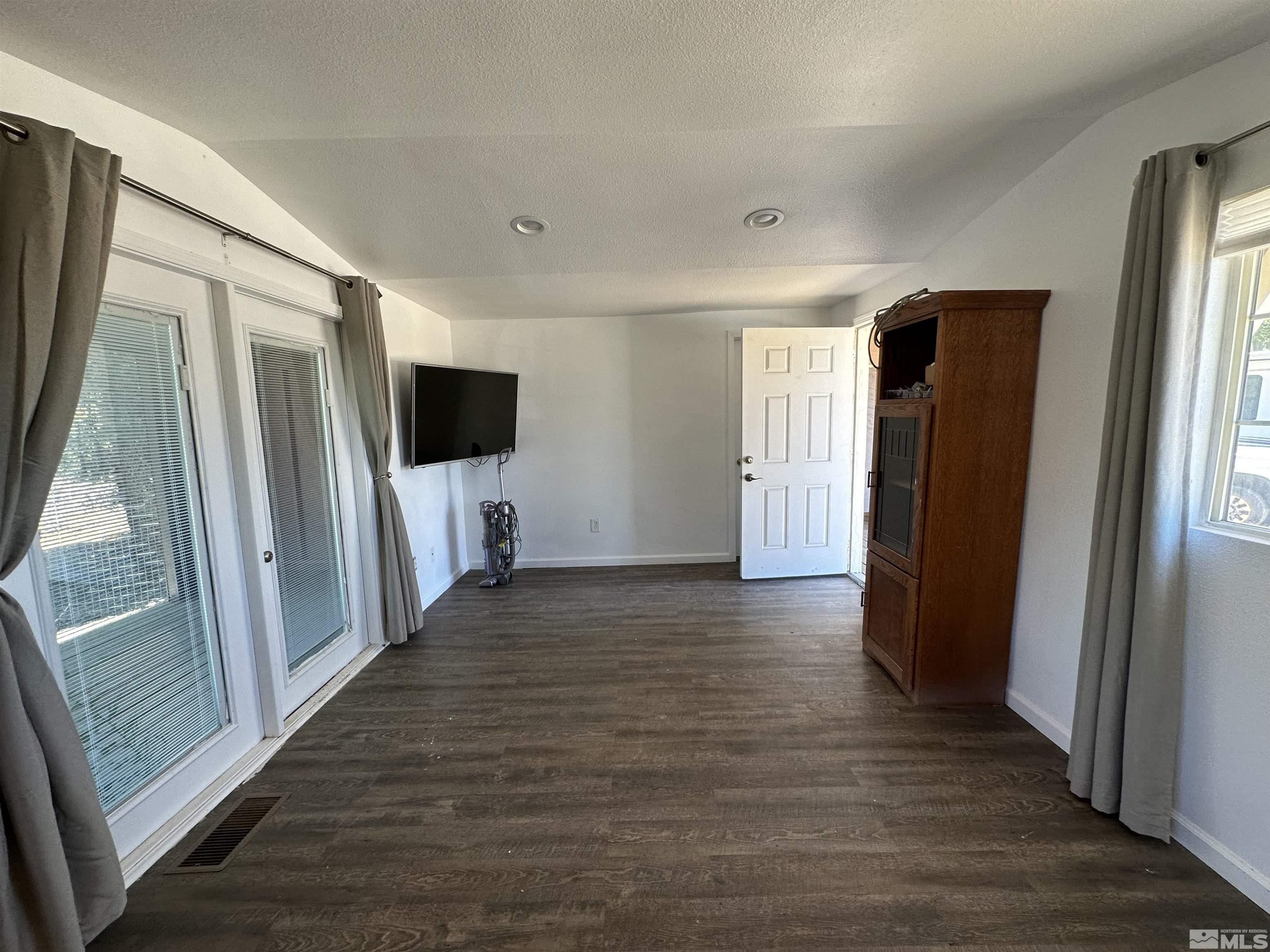 15119 Kivett Lane Reno, NV 89521 - Photo 4 of 20 a view of a livingroom with wooden floor and a window