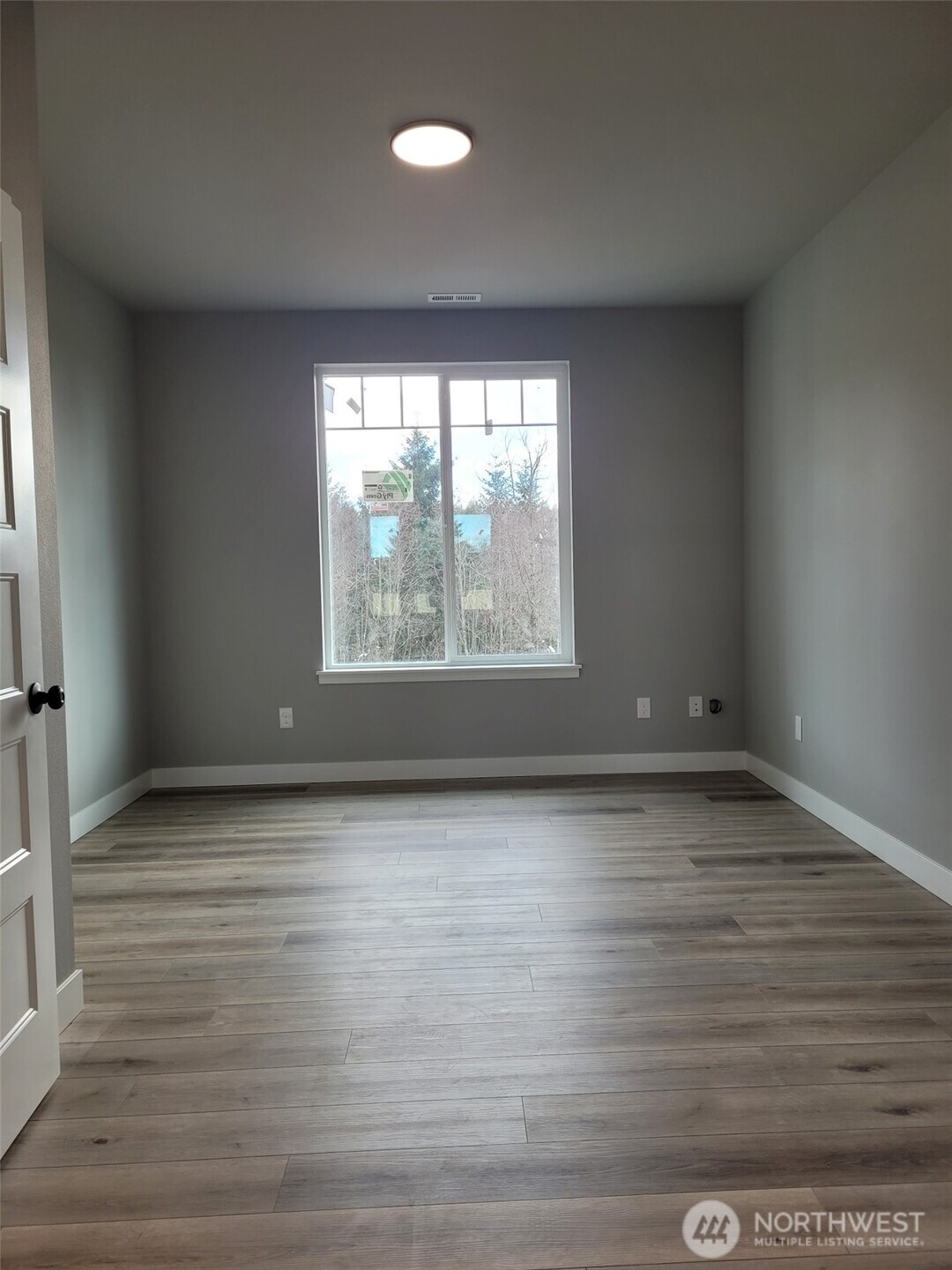 22 Raven Lane Elma, WA 98541 - Photo 13 of 21 a view of an empty room with wooden floor and a window