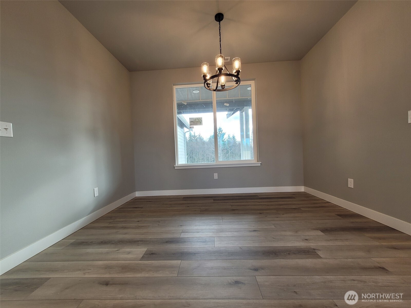 22 Raven Lane Elma, WA 98541 - Photo 16 of 21 a view of wooden floor chandelier and window in a room
