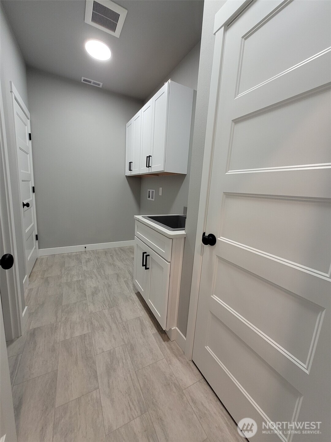 22 Raven Lane Elma, WA 98541 - Photo 19 of 21 a kitchen with white cabinets and white appliances