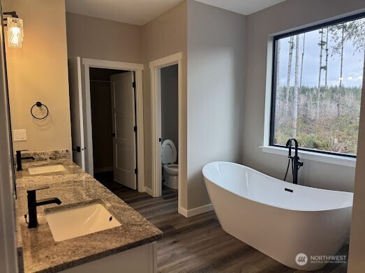 22 Raven Lane Elma, WA 98541 - Photo 21 of 21 a bathroom with a granite countertop tub sink and mirror