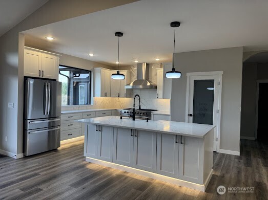 22 Raven Lane Elma, WA 98541 - Photo 7 of 21 a kitchen with kitchen island a sink stainless steel appliances and wooden floor