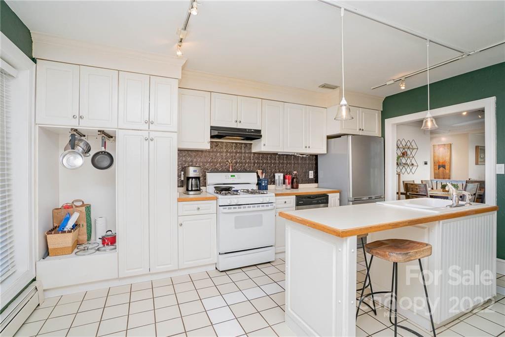 660 6th Street Northwest Hickory, NC 28601 - Photo 13 of 39 a kitchen with stainless steel appliances a refrigerator sink and white cabinets