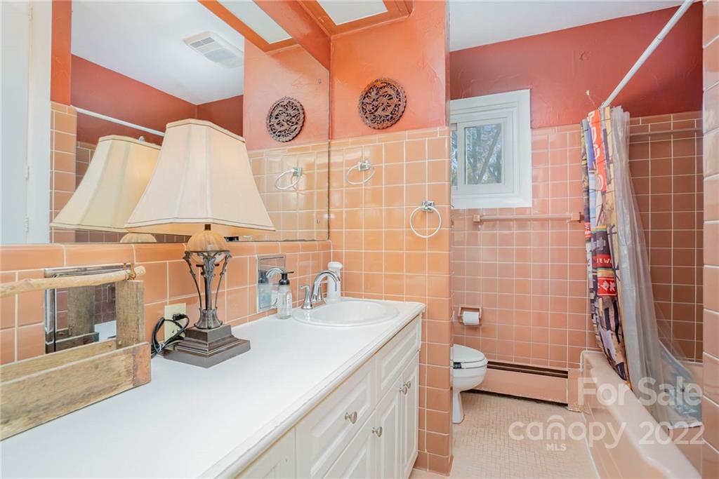 660 6th Street Northwest Hickory, NC 28601 - Photo 24 of 39 a bathroom with a sink a toilet and shower