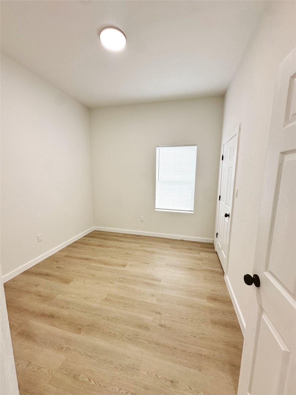 9723 Kerr A-b Street Houston, TX 77029 - Photo 13 of 22 a view of an empty room with wooden floor and a window