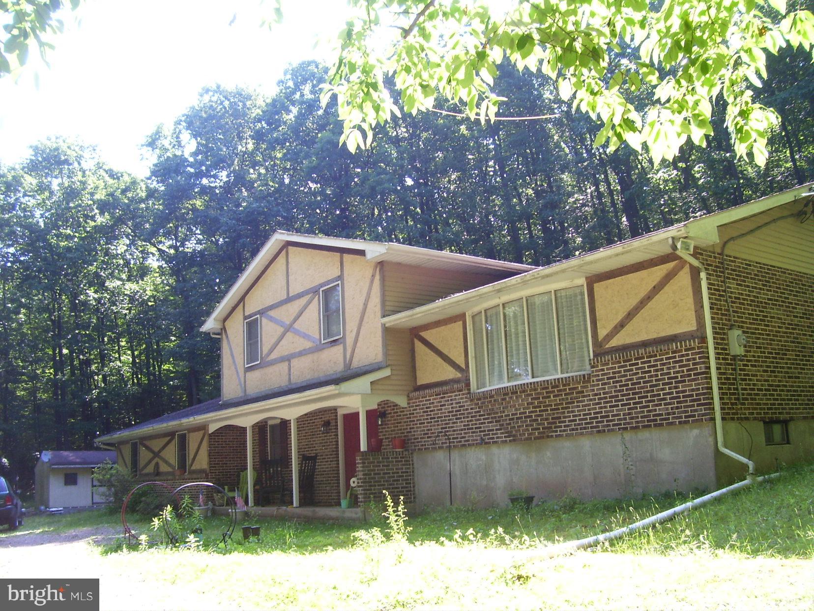 332 Hunters Road Mohnton, PA 19540 - Photo 1 of 16 a backyard of a house with wooden fence and large trees