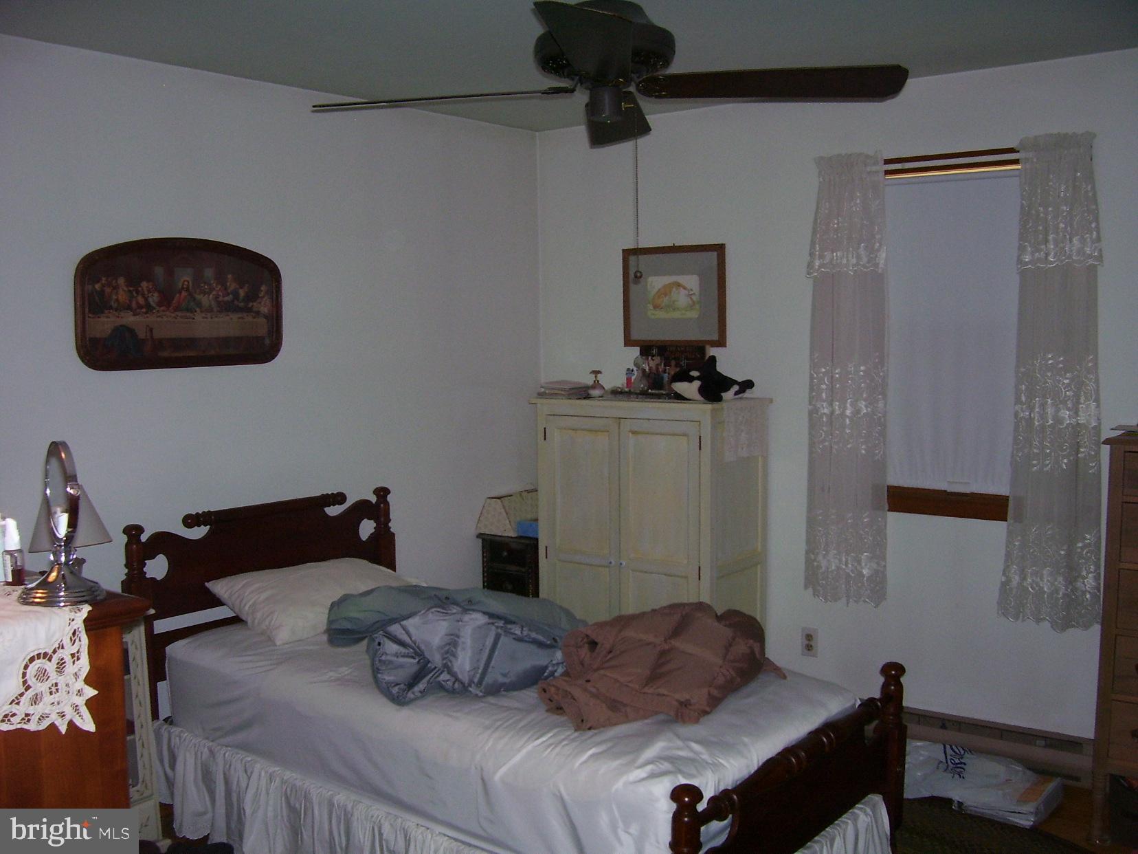 332 Hunters Road Mohnton, PA 19540 - Photo 12 of 16 a bedroom with a bed and wooden floor