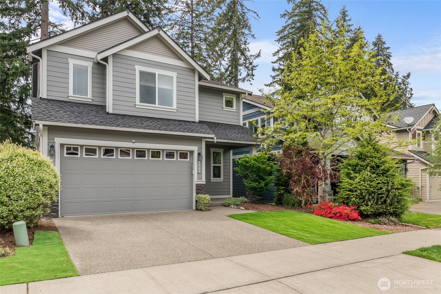 4335 Dudley Drive Northeast Lacey, WA 98516 - Photo 2 of 39 a front view of a house with a yard and garage