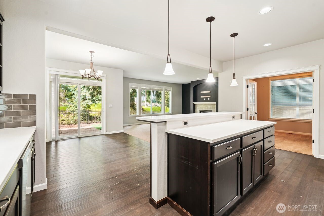 4335 Dudley Drive Northeast Lacey, WA 98516 - Photo 23 of 39 a kitchen with a stove and a wooden floor