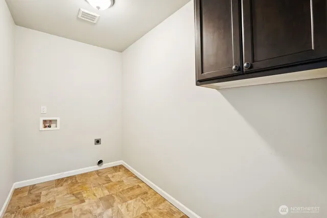 a view of an empty room with a window and a fireplace