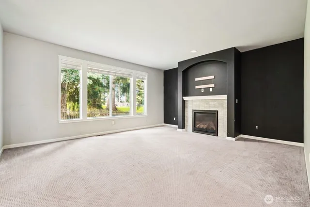 a view of an empty room with a fireplace