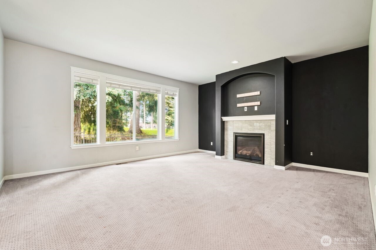4335 Dudley Drive Northeast Lacey, WA 98516 - Photo 26 of 39 a view of an empty room with a window and a fireplace