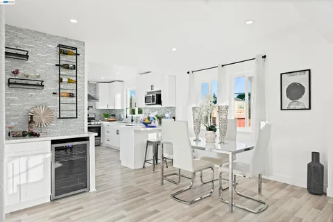 a kitchen with kitchen island granite countertop wooden cabinets and stainless steel appliances