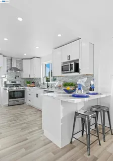 a kitchen with cabinets stainless steel appliances and a sink