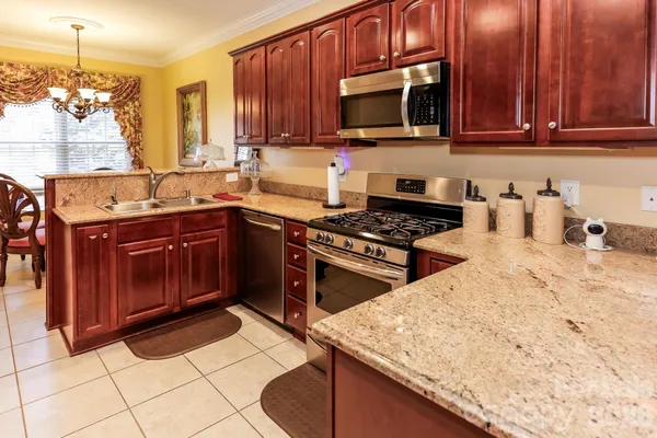 a kitchen with a sink stove top oven and cabinets