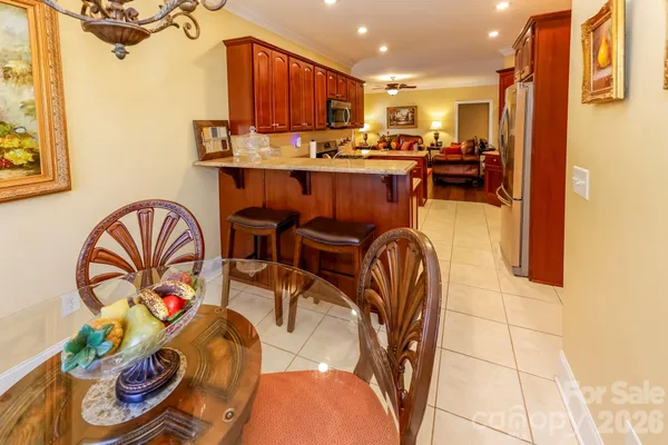 a kitchen with stainless steel appliances granite countertop a sink and a refrigerator