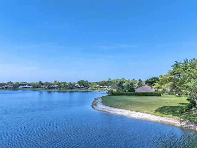 a view of a lake with houses in the back