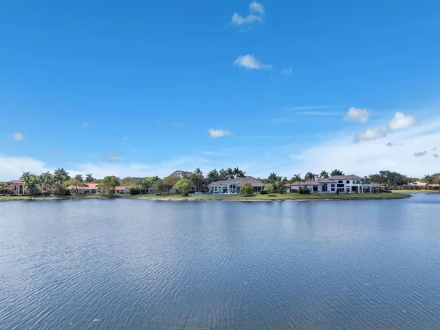 a view of a lake with houses in the back