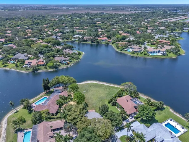 an aerial view of lake and residential houses with outdoor space
