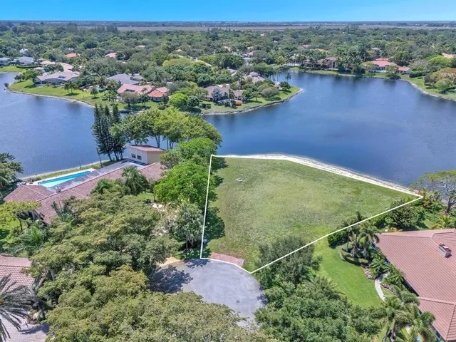 an aerial view of residential houses with outdoor space and river