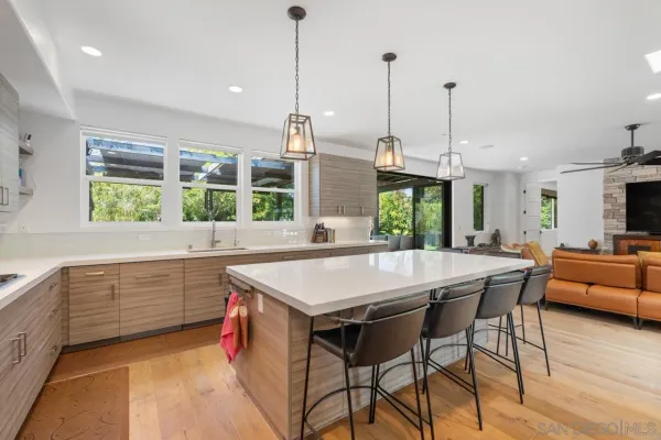 a kitchen with stainless steel appliances granite countertop a kitchen island a stove and a sink